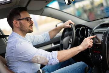 Man Using Gps Navigation System In Car
