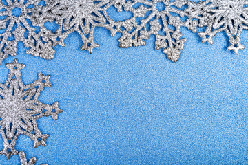 Silvery snowflakes on a blue background.