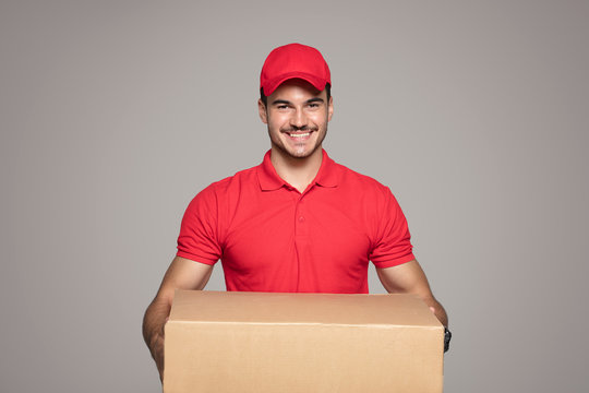 Smiling courier man holding a box package.