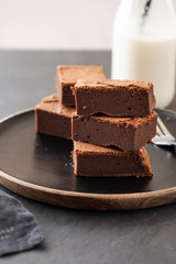 Double Chocolate Brownies. Homemade chocolate fudge brownies with chocolate chips and black background. Copy space.