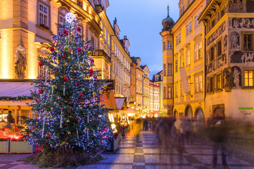 Prague Christmas market on the night in Old Town Square with blurred people on the move. Prague,...