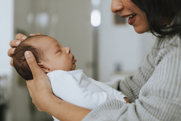 Mother holding her infant baby