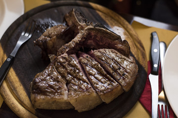 adult beef steak served on a wooden chopping board