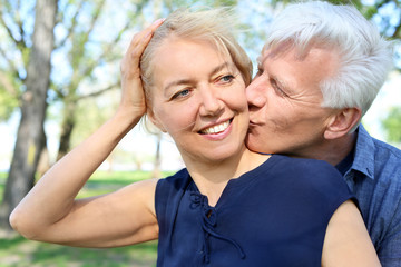 Fototapeta premium Mature couple resting in park on spring day