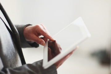 close up.blurred image businessman presses on the screen of a digital tablet.photo with copy space