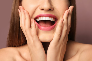 Fototapeta premium Beautiful young woman with pink lipstick on color background, closeup