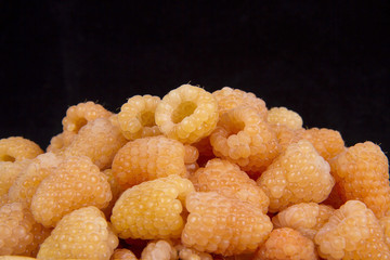 yellow raspberry on a black background