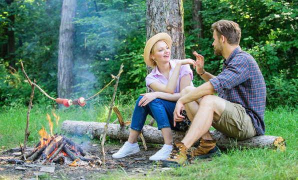 Pleasant smell of roasted food makes picnic atmosphere perfect. Picnic roasting food over fire. Idyllic picnic date. Family enjoy weekend in nature. Couple in love relaxing sit on log having snacks