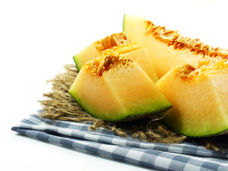 close up of cantaloupe melon slices on white background