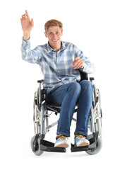Fototapeta na wymiar Young man sitting in wheelchair on white background