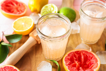 Jars with refreshing grapefruit lemonade on table