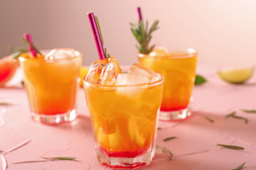 Fresh summer cocktail in glass on color table