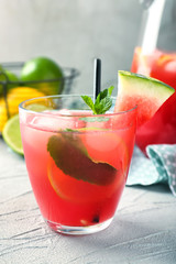 Glass of fresh watermelon lemonade on table