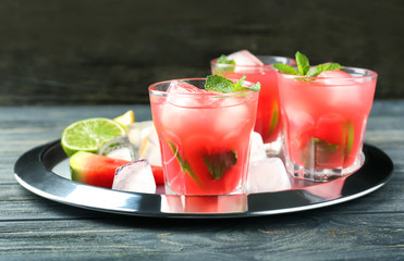 Glasses of fresh watermelon lemonade on metal tray