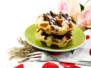 freshly sweet waffles on a tablecloth background