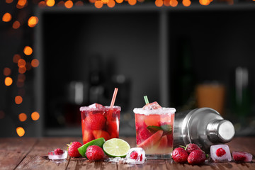 Fresh summer cocktails in glasses on wooden table in bar