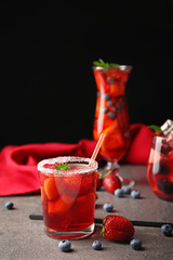 Fresh summer cocktail in glass on grey table