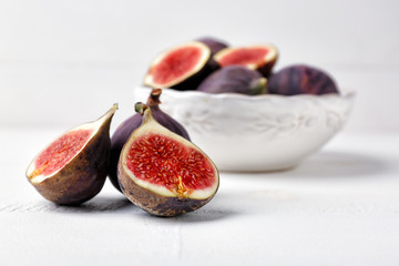 Fresh ripe figs on white table