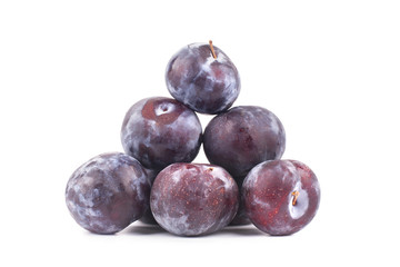 Plums in the form of a pyramid on a white background isolated close up