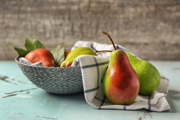 Bowl with ripe sweet pears on table