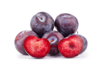 Two halves of a plum in the form of hearts red inside with a stone on a white background isolated close up