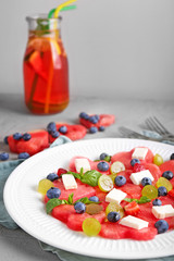 Plate with sweet watermelon salad on table, closeup