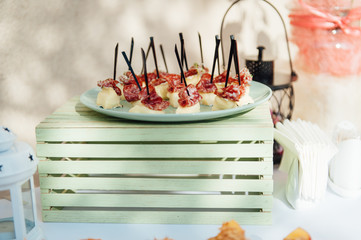 Delicious snacks on wedding reception table in luxury outdoor restaurant
