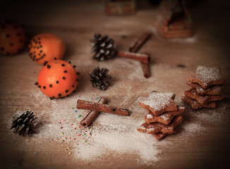 Christmas table. background image of cinnamon sticks,oranges an