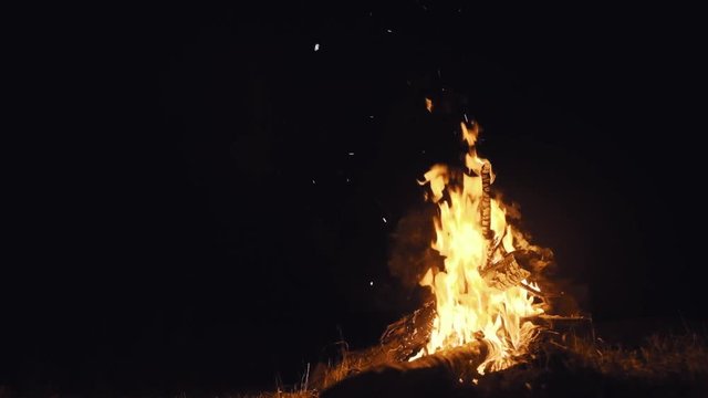 Romantisches Lagerfeuer in Zeitlupe mit Funkenflug bei Nacht