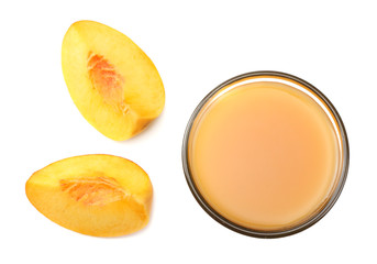 glass of peach juice with peach fruit, green leaf and slices isolated on white background. top view