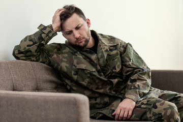 Unhappy and sad soldier in green moro uniform with war syndrome - obrazy, fototapety, plakaty