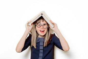 Portrait of a nerd girl in glasses with books on white background