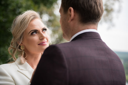 Romantic newlyweds exploring views from balcony