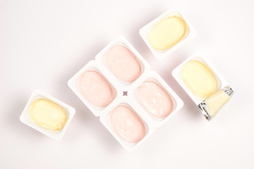 Plastic cup with tasty yogurt isolated on white. Top view. Space for text or design.