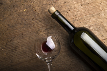 Red wine glasses and bottle on stone background. Top view with copy space