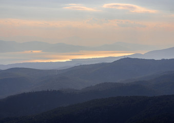 Naklejka na ściany i meble Panoramic view from the mountain pass to the Greek island of Evia and the Aegean Sea at sunset