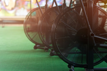 Close-up - air bikes for intensive cardio workout in the gym. Crossfit equipment.
