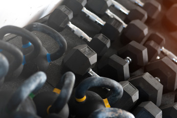 Obraz premium Gym equipment. Rows of different weights kettle bells and dumbbells on the floor. Crossfit and sports.