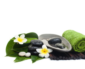 spa tropical objects with towel, flowers and black stones
