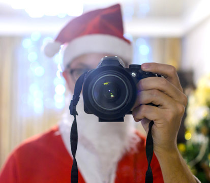Portrait Santa takes pictures with  DSLR camera