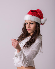 Young woman in Santa Claus hat posing