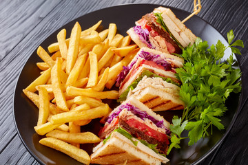 Delicious classic club sandwich with French fries