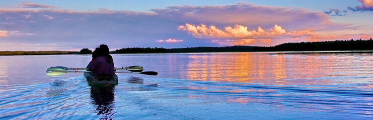 Kayaking on a lake at sunset, Karelia