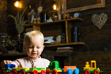 Fototapeta na wymiar Nursery child play with toy train in playroom. Nursery and kindergarten