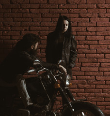 biker. bearded biker and girl with motorcycle. biker club concept. biker couple has road trip....