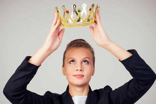 Young Business Woman Put On The Crown On Head. Leadership, Success Concept