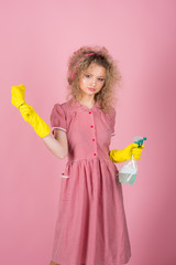 Pretty woman ready to do housework. Housework helper in rubber gloves with cloth and sprayer bottle. Extreme clean
