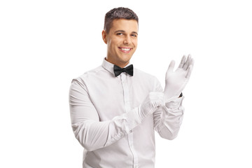 Young guy in a tuxedo putting on gloves