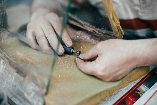 Hands making engraving job