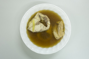 Top view of fish soup in white bowl. Healthy meal.